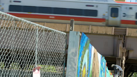 Elevated-Train-Passing-over-Fence-and-Graffiti-in-New-York-City