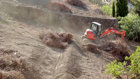 Excavator-at-work,-moving-trees-and-earth-for-a-construction-site