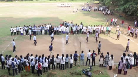 College-students-playing-volleyball-on-the-ground