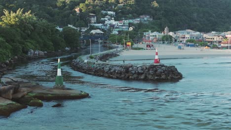 Barra-Da-Lagoa-town,-aerial-view-from-lighthouses-at-the-entrance-to-the-canal