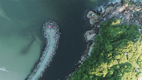 Aerial-top-view-of-person-kayaking-the-Barra-Da-Lagoa-canal,-Santa-Catarina,-Florianópolis,-Brazil