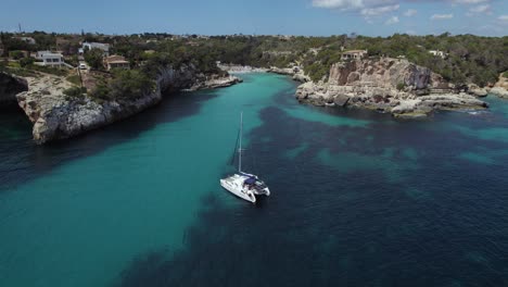 Boat-In-Beautiful-Water-At-Mallorca-In-Spain,-Drone-Shot