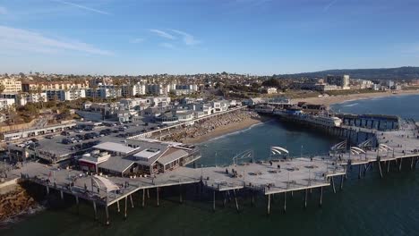 Aerial-footage-orbiting-over-Redondo-Beach-pier-in-California-on-a-sunny-and-bright-day