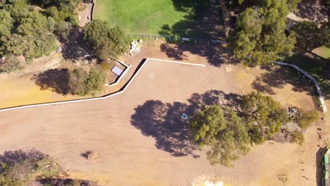 Aerial-tilt-up-to-reveal-Riverlinks-Park-all-abilities-playground-construction,-Perth