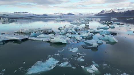 Drone-shot-of-floating-ice-in-water-in-Iceland-during-winter-in-the-morning