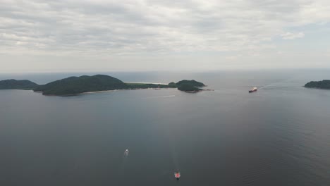 Aerial-view-of-ship-and-boats-sailing-near-Ilha-do-Mel-in-Paranagua-Bay,-Parana,-Brazil
