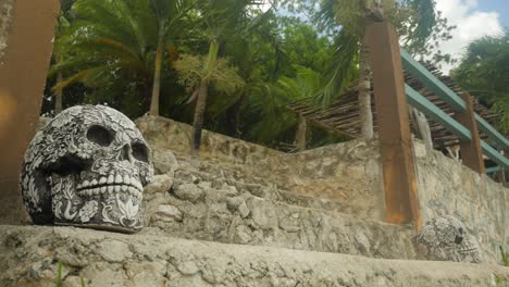 Mexican-sculpted-skulls-on-stairs-in-tropical-setting