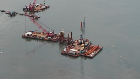 Aerial-view-close-up-of-floating-platforms-on-cargo-cranes-in-port-of-São-Francisco-do-Sul