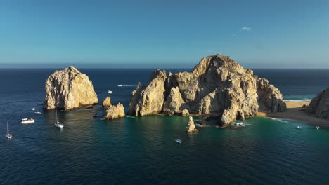 Drone-shot-approaching-the-cape-of-Cabo-San-Lucas,-sunny-evening-in-Mexico