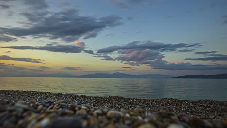 Rocky-beach-and-flowing-clouds,-time-lapse-view