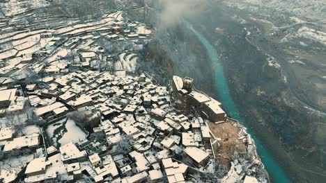 Aerial-Overhead-View-Of-Snow-Covered-Altit-Fort-In-Hunza-Valley