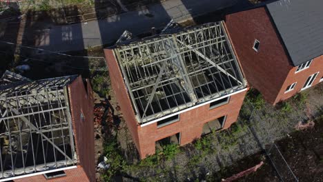 Residential-housing-estate-aerial-view-looking-down-over-unfinished-property-framework-on-building-development-site-during-recession