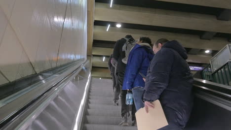 Escalator-inside-the-metro-with-people-going-up