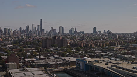 NYC-New-York-Aerial-v191-low-flyover-Red-Hook-capturing-Brooklyn-residential-neighborhood,-waterfront-industrial-area-and-downtown-cityscape-on-the-skyline---Shot-with-Inspire-3-8k---September-2023