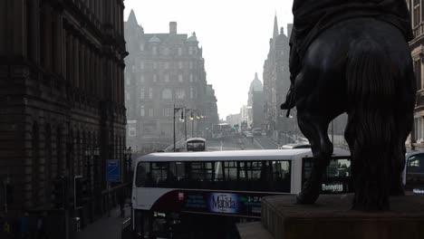 A-moody-shot-of-a-busy-city-street-with-a-statue-of-Wellington-in-the-foreground