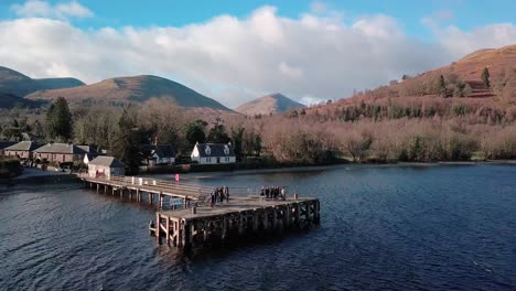 Aerial-reveal-shot-from-a-pier-at-Loch-Lomond-in-the-highlands-of-Scotland