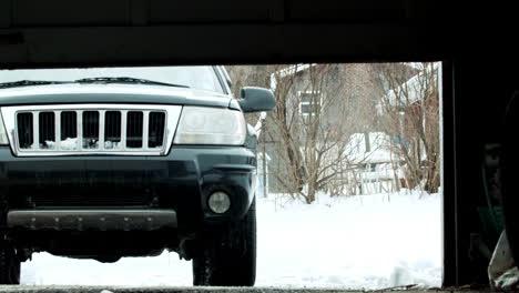 Car-Pulling-into-Garage-From-Snowy-Driveway-SLIDE-RIGHT