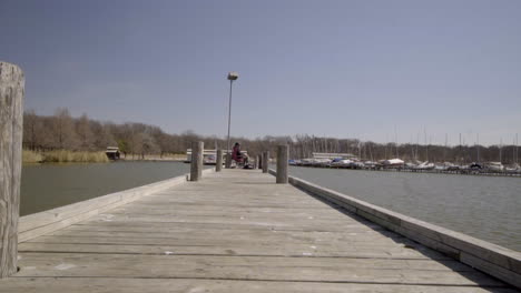 This-is-a-static-shot-of-a-man-fishing-at-the-end-of-a-long-Pier