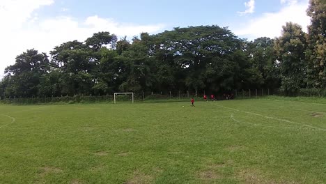View-of-a-group-of-young-women-in-the-middle-of-a-soccer-training,-recorded-from-a-drone
