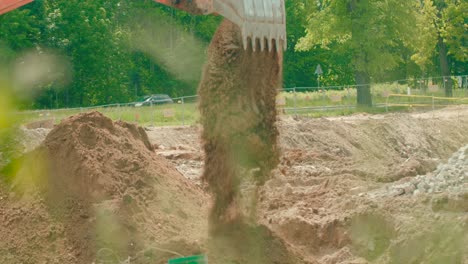 An-excavator-digs-clay-soil-in-a-foundation-pit-to-build-a-foundation