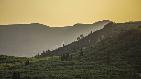 Scenic-mountain-landscape-with-light-mist-and-sunset-glow,-static-view