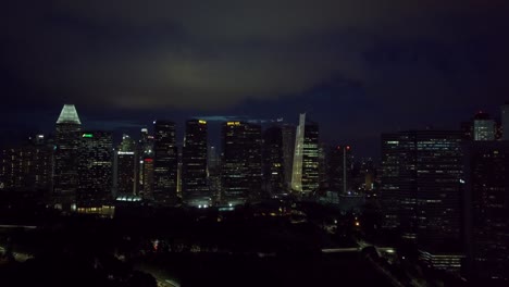 Aerial-approach-drone-shot-of-Singapore-skyscrappers-at-night