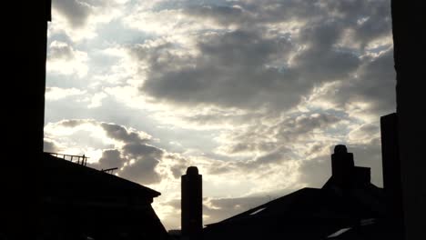 Dramatic-Cloud-Time-Lapse-View-Through-Window-Of-Sunset-Over-Buildings-In-Frankfurt,-Germany