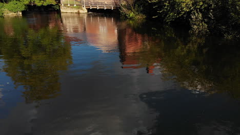 Aerial-footage-of-Flatford-Mill-from-the-front-and-rising-up-to-reveal-the-landscape-beyond