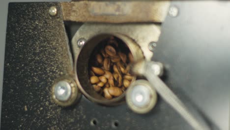 Raw-Coffee-Beans-Tossing-Spinning-Inside-Stainless-Steel-Roasting-Machine,-Close-Up