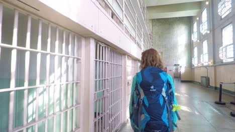 Woman-walking-near-the-prison-cells-of-Alcatraz-in-San-Francisco,-USA