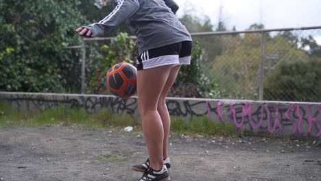 Athletic-girl-doing-soccer-tricks-and-turns-outside-in-isolation