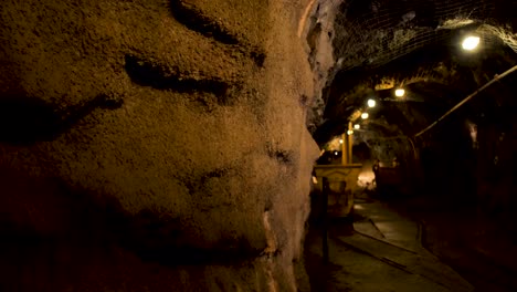 A-miner-walking-with-a-flashlight-through-an-old-Squamish-mine-shaft