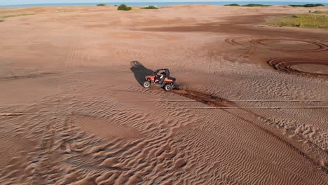 Slow-motion-version-shot-of-a-dune-buggy-drifting-in-the-middle-of-the-desert