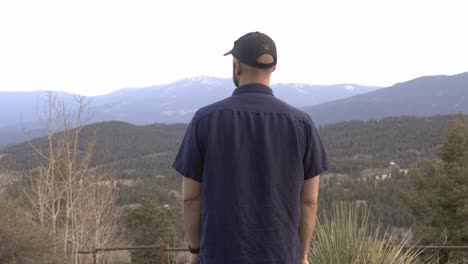 Man-looking-out-over-national-forest-and-the-Lost-Creek-Wilderness-area-near-Bailey,-Colorado