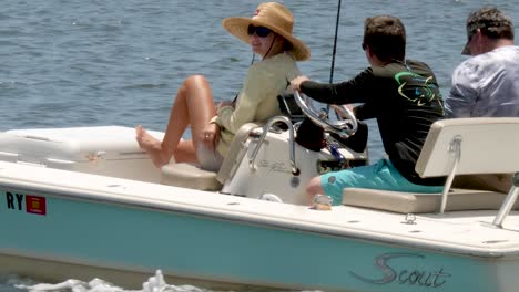 CLOSE-UP:-Family-woman-with-hat,-son-driving,-and-father-in-boat-on-a-beautiful-summer-day-on-the-inter-coastal-waterway
