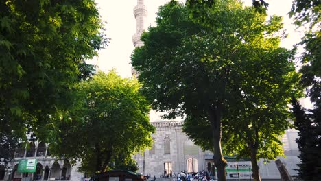 Unidentfied-people-exit-gate-of-Blue-Mosque-or-Sultan-Ahmet-Mosque,-a-popular-landmark-in-Istanbul,-Turkey