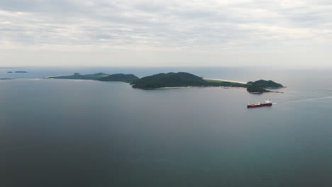 Large-cargo-ship-sailing-near-the-coast-of-Ilha-do-Mel,-Paranagua-Bay,-Paraná-State,-Brazil