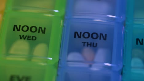 Macro-of-pill-organizer-in-different-colors-to-keep-medications-organized-by-day