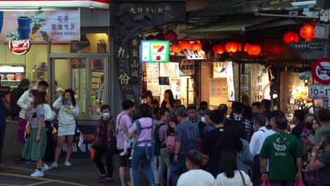 Large-crowd-of-people-at-the-entrance-of-Jiufen-Old-Street,-a-gold-mining-mountain-town,-a-popular-tourist-attraction-in-Taiwan