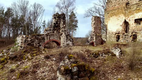 Rural-countryside-aerial-autumnal-landscape,-European-old-fort-castle-ruins-sky