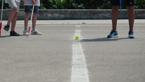 Slow-motion-shot-of-children-getting-ready-to-play-street-hockey