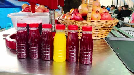 Juicer-man-selling-his-fruit-stall-to-make-a-fresh-pomegranate-juice-with-squeeze-machine