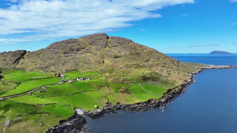 Drone-landscape-remote-beauty-of-Cods-Head-Peninsula-West-Cork-Ireland,-sturdy-farmhouse,mountains,islands-and-inlets,the-beauty-the-Wild-Atlantic-Way-offers