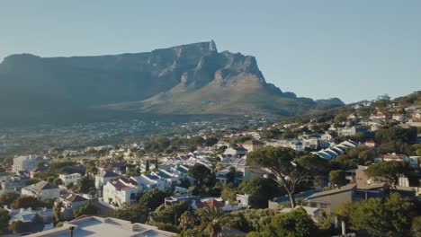 Drone-flying-close-by-scenic-buildings-towards-the-mountains-in-Cape-Town-South-Africa