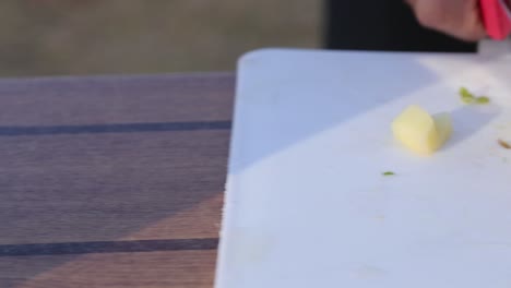 Pan-shot-of-Chef's-hands-slicing-cheese-slices_close-up