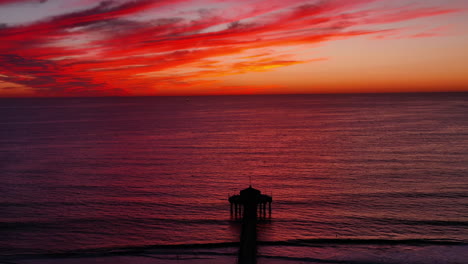 Pintoresco-Paisaje-Del-Muelle-De-Manhattan-Beach-Con-Cielos-Rojos-Al-Atardecer-En-California,-Estados-Unidos