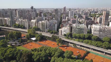 Buenos-Aires-drone-view-of-Nordelta-park-highway-and-skyscrapers,-Bosques-de-Palermo-Tres-de-Febrero-aerial-pull-out-shot