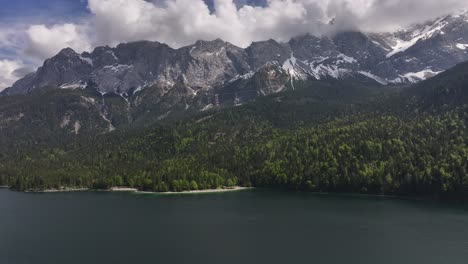 Hovering-above-Eibsee-in-Grainau,-Germany,-against-a-backdrop-of-breathtaking-mountains