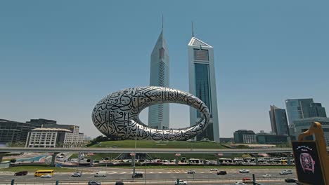 Una-Vista-Impresionante-Del-Museo-Del-Futuro-De-Dubai,-Junto-Con-La-Carretera-Sheikh-Zayed-Y-El-Tráfico-De-La-Ciudad.