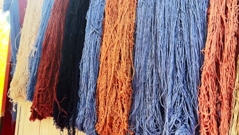 weaves-a-wool-carpet-with-her-hands-on-a-loom,-Turkish-handmade-carpets,-Cappadocia,-Turkey